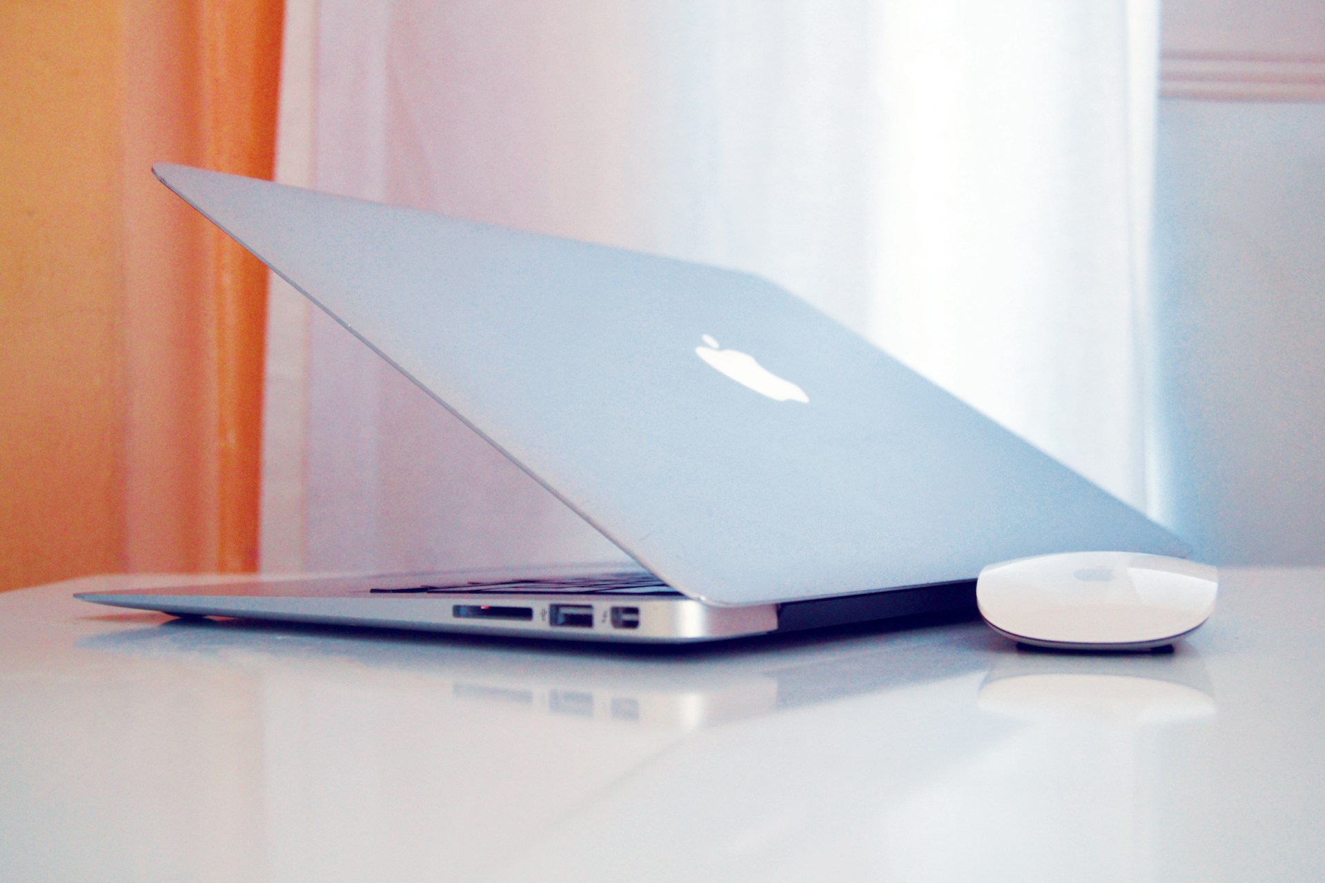 MacBook on a desk in soft window light